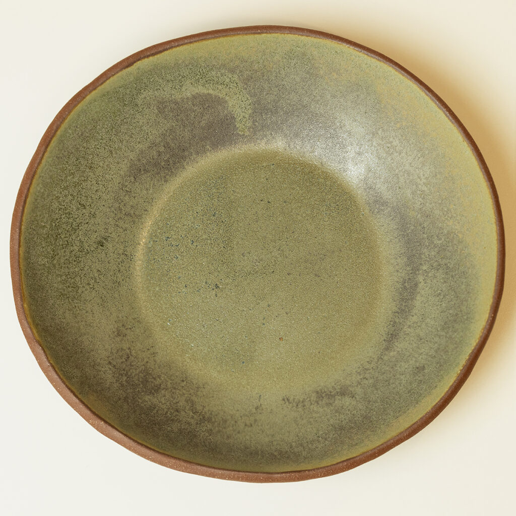 ceramiczny głęboki talerz z czerwonej gliny szkliwiony na zielono z szaro-butelkowe odmianki.